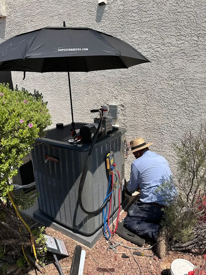 HVAC technician performing outdoor AC maintenance in Reserve